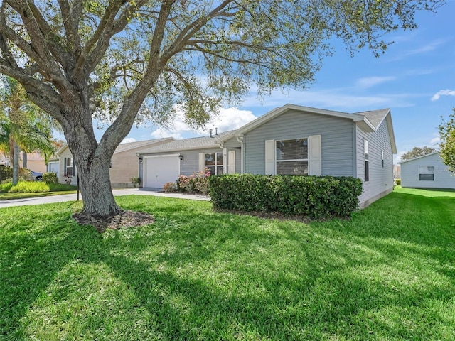 ranch-style home featuring an attached garage, concrete driveway, and a front yard