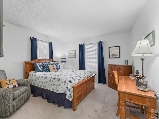 bedroom featuring a textured ceiling and light colored carpet