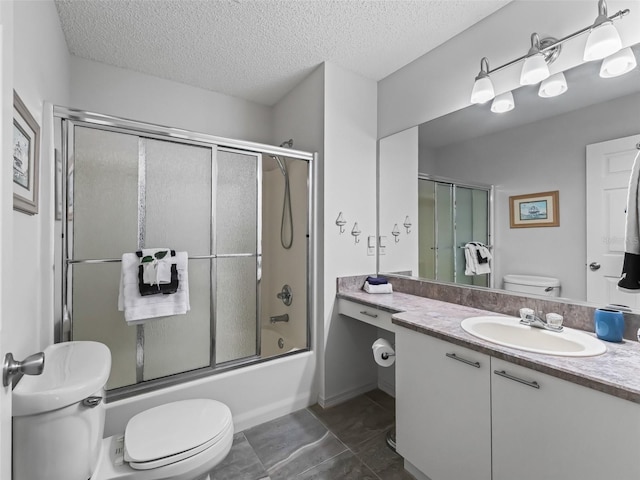 bathroom with a textured ceiling, vanity, toilet, and enclosed tub / shower combo