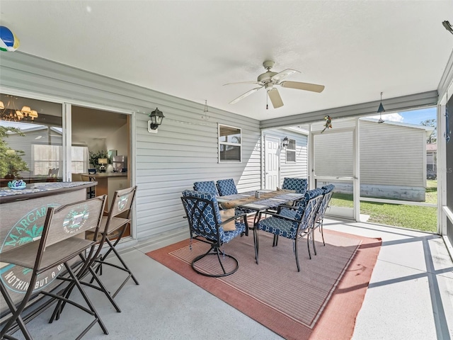 sunroom / solarium with a ceiling fan