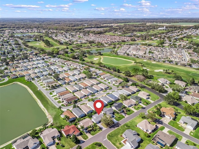 aerial view with view of golf course, a water view, and a residential view