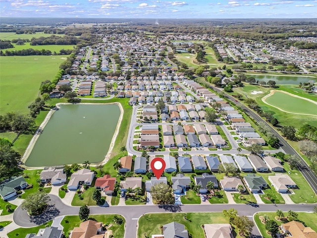 bird's eye view featuring a water view, view of golf course, and a residential view