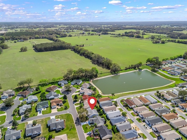 birds eye view of property with a water view and a residential view