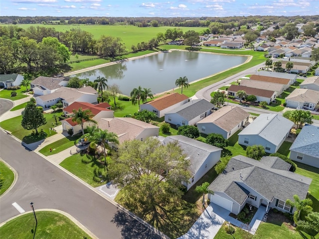 drone / aerial view with a water view and a residential view