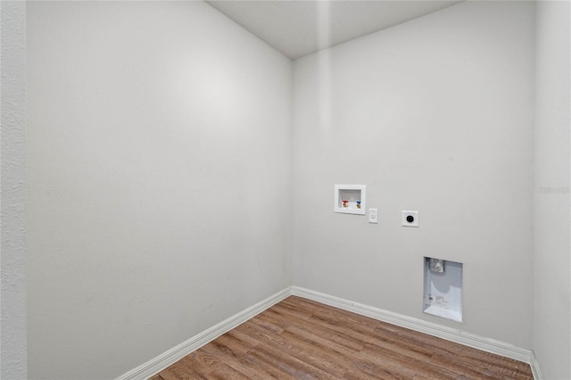 laundry room featuring hookup for an electric dryer, laundry area, washer hookup, wood finished floors, and baseboards