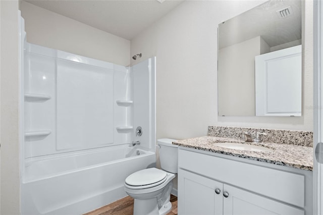 full bathroom featuring visible vents, toilet, tub / shower combination, vanity, and wood finished floors