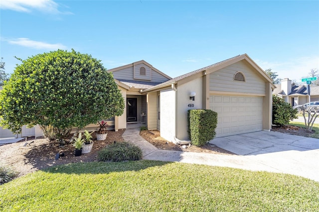 view of front of home with a garage, stucco siding, concrete driveway, and a front yard