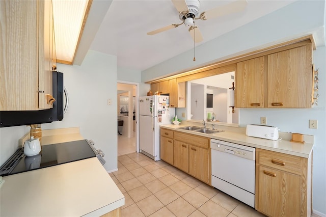 kitchen featuring light brown cabinetry, white appliances, a sink, and light countertops