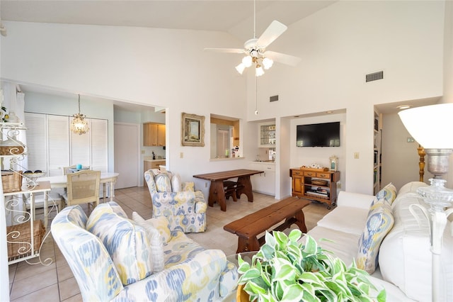 living room with ceiling fan, visible vents, vaulted ceiling, and light tile patterned flooring