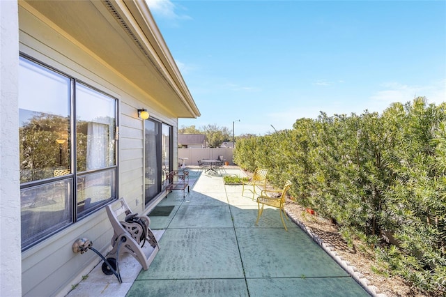 view of patio featuring fence