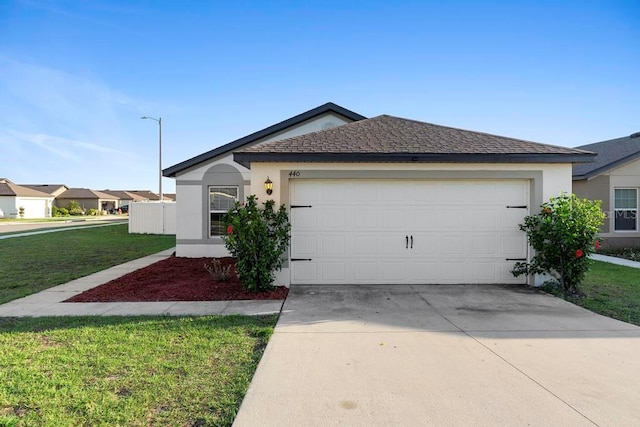 ranch-style house with a garage, a front yard, driveway, and stucco siding