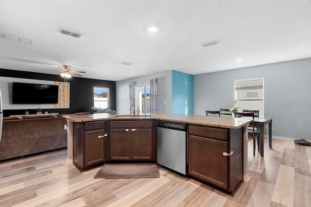 kitchen with light wood-style floors, visible vents, dark brown cabinetry, and stainless steel dishwasher