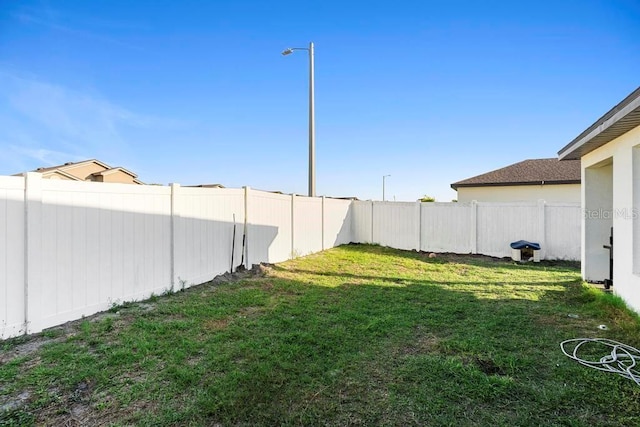 view of yard with a fenced backyard