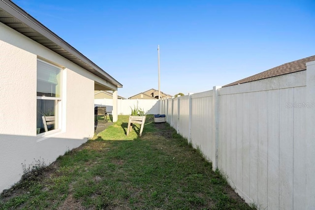 view of yard with a fenced backyard