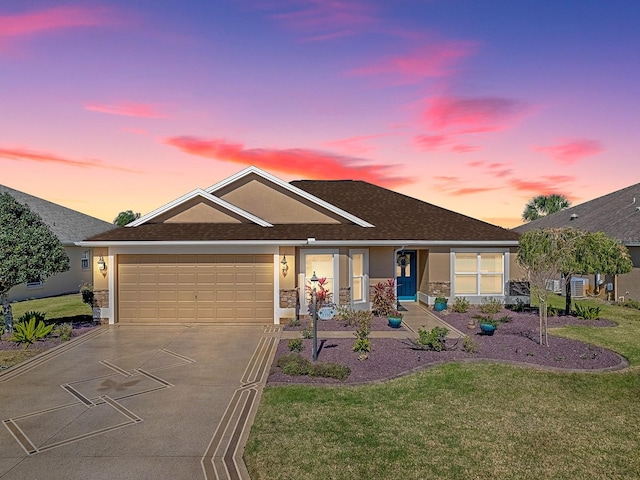 ranch-style house with concrete driveway, a yard, an attached garage, and stucco siding