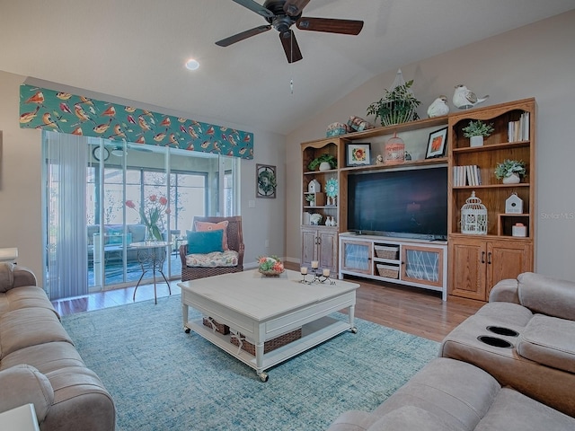 living room featuring a ceiling fan, lofted ceiling, and wood finished floors