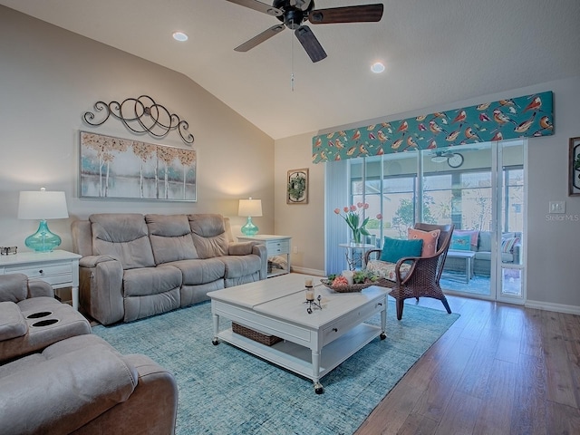 living area with lofted ceiling, wood finished floors, a ceiling fan, and baseboards