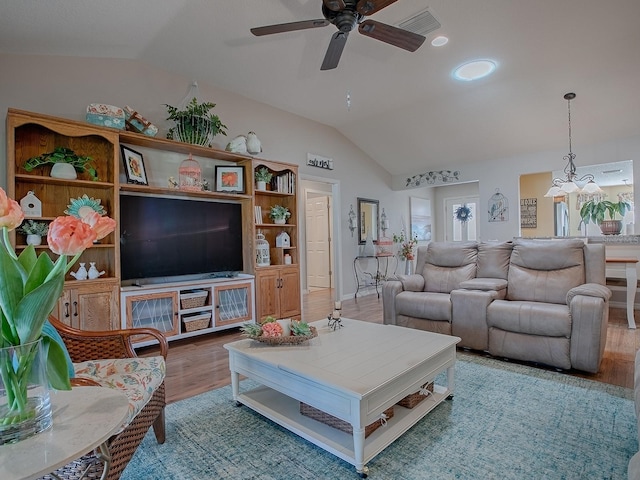 living area with vaulted ceiling, ceiling fan, wood finished floors, and visible vents