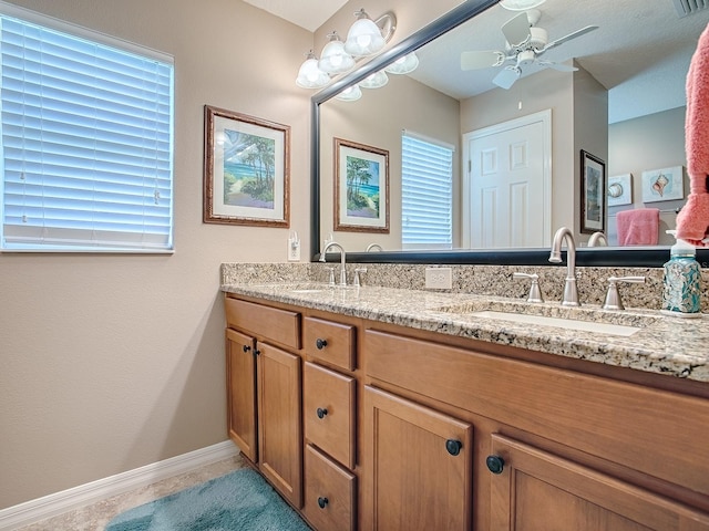 bathroom with ceiling fan, a sink, and a healthy amount of sunlight