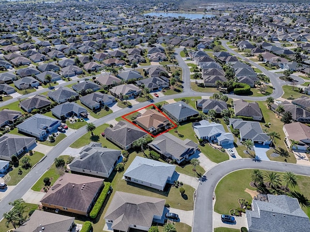 drone / aerial view featuring a residential view and a water view