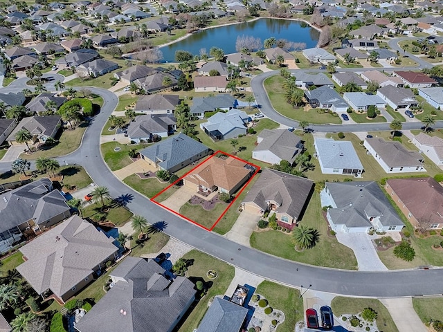 drone / aerial view featuring a residential view and a water view