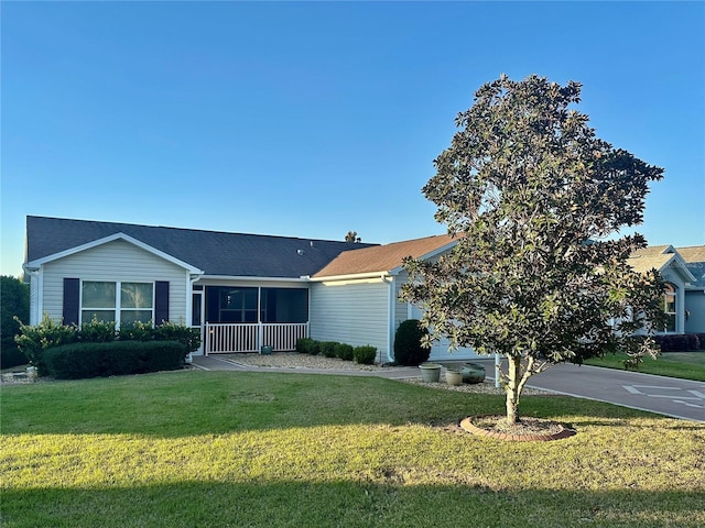 ranch-style house with an attached garage, concrete driveway, and a front yard