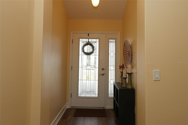 entryway with baseboards and dark wood-style flooring