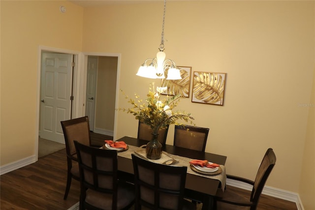 dining area with dark wood-style floors, baseboards, and a chandelier