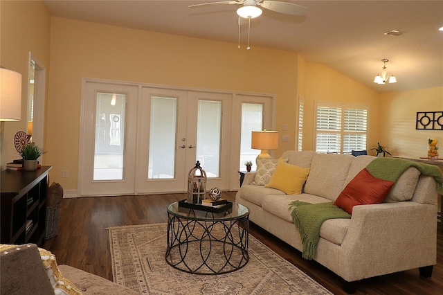 living room with lofted ceiling, visible vents, dark wood-style flooring, and ceiling fan with notable chandelier