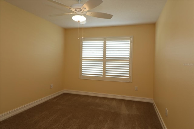 carpeted empty room featuring ceiling fan and baseboards