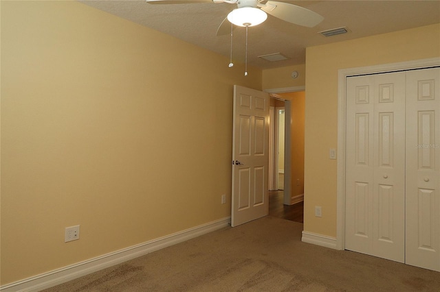 unfurnished bedroom with baseboards, carpet, visible vents, and a closet