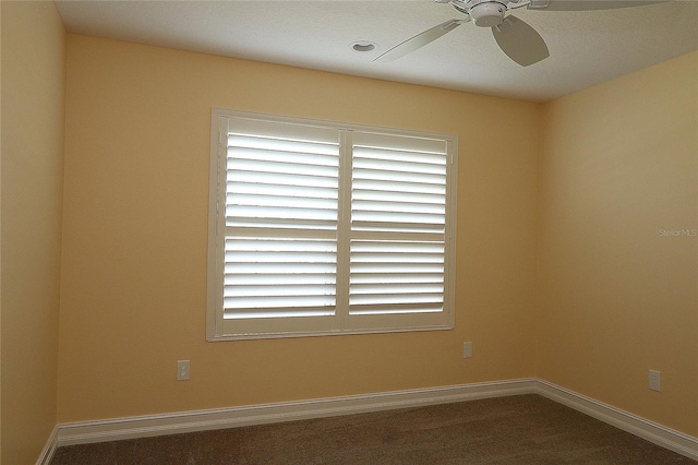 unfurnished room with a ceiling fan and baseboards