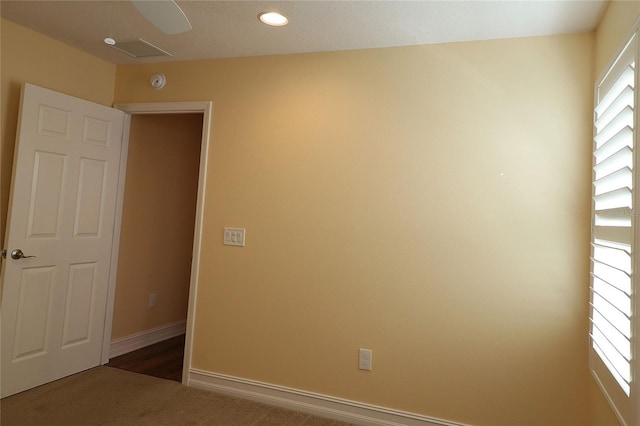 carpeted empty room featuring baseboards and recessed lighting