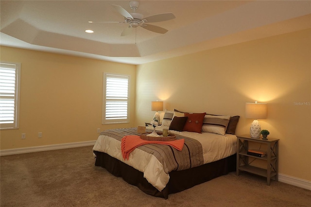 bedroom featuring carpet floors, recessed lighting, a raised ceiling, and baseboards