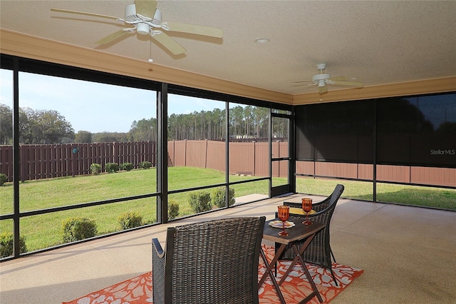 sunroom / solarium featuring ceiling fan and a wealth of natural light