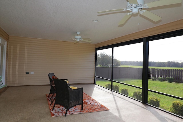 sunroom featuring a ceiling fan