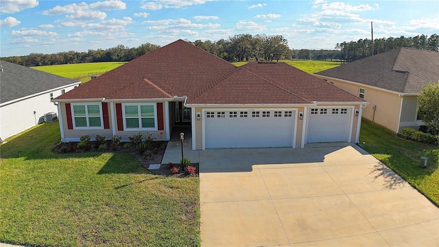 ranch-style house with a garage, driveway, and a front lawn