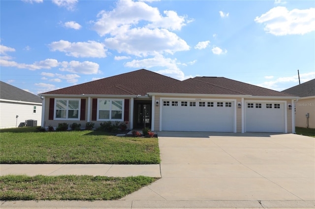 ranch-style house with an attached garage, concrete driveway, a front yard, and cooling unit