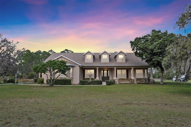 view of front of property featuring covered porch and a front yard