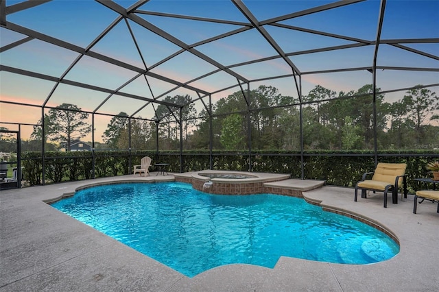 view of pool with glass enclosure, a pool with connected hot tub, and a patio