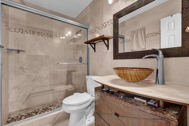 bathroom with vanity, decorative backsplash, toilet, and a stall shower