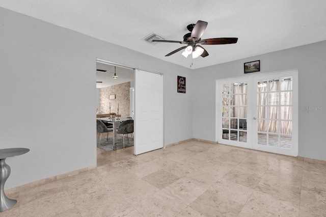 unfurnished room with french doors, baseboards, a textured ceiling, and ceiling fan