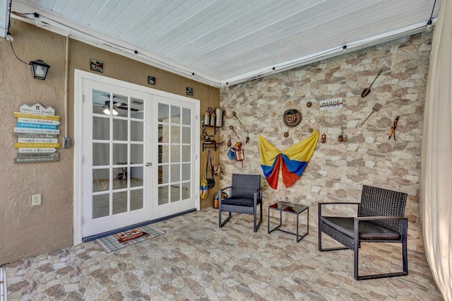 exterior space with french doors and a textured wall