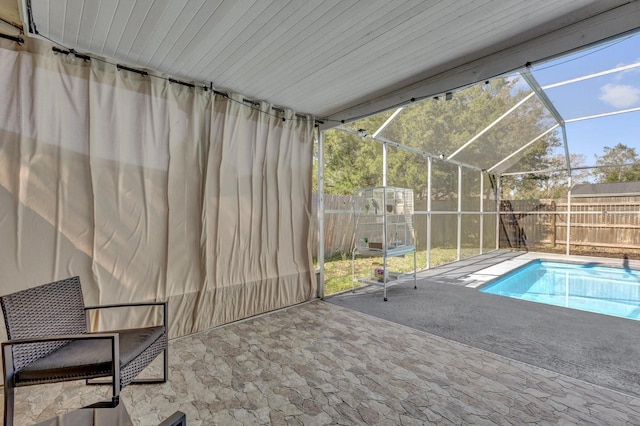 view of swimming pool featuring a fenced backyard, a patio, a fenced in pool, and a lanai