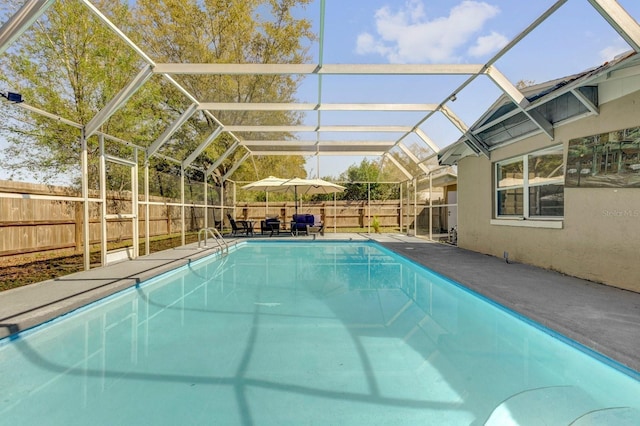 view of swimming pool featuring a patio area, a fenced backyard, a fenced in pool, and a lanai