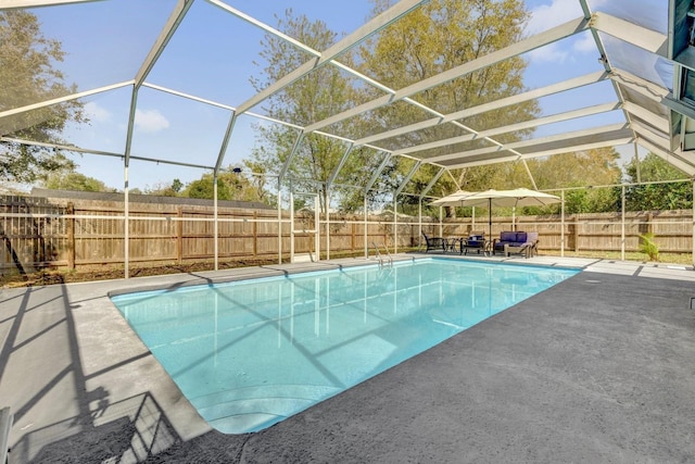 view of swimming pool with a lanai, a patio area, a fenced in pool, and a fenced backyard