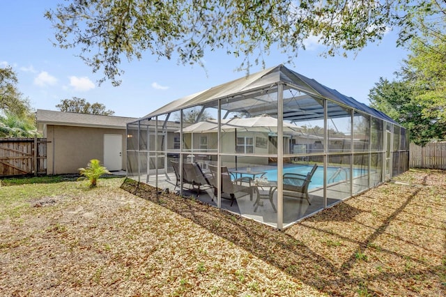 exterior space featuring a patio area, a fenced backyard, a fenced in pool, and a lanai