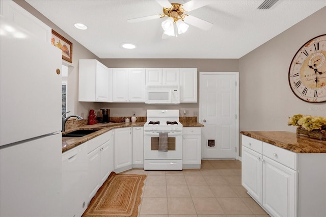 kitchen featuring light tile patterned floors, white appliances, a sink, visible vents, and white cabinetry