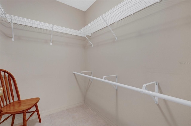 spacious closet with light tile patterned floors