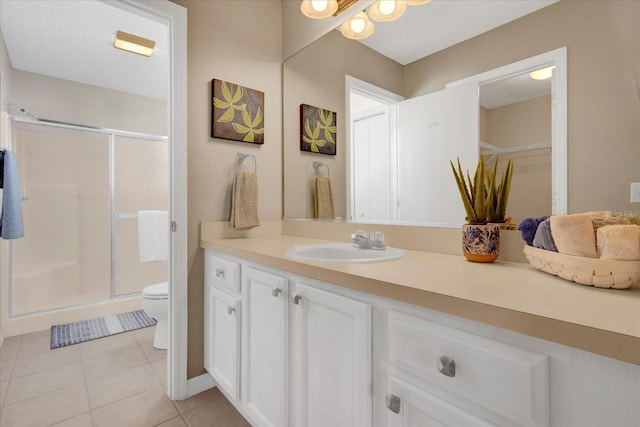 bathroom with toilet, a stall shower, tile patterned flooring, and vanity